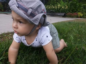 Baby crawling in grass