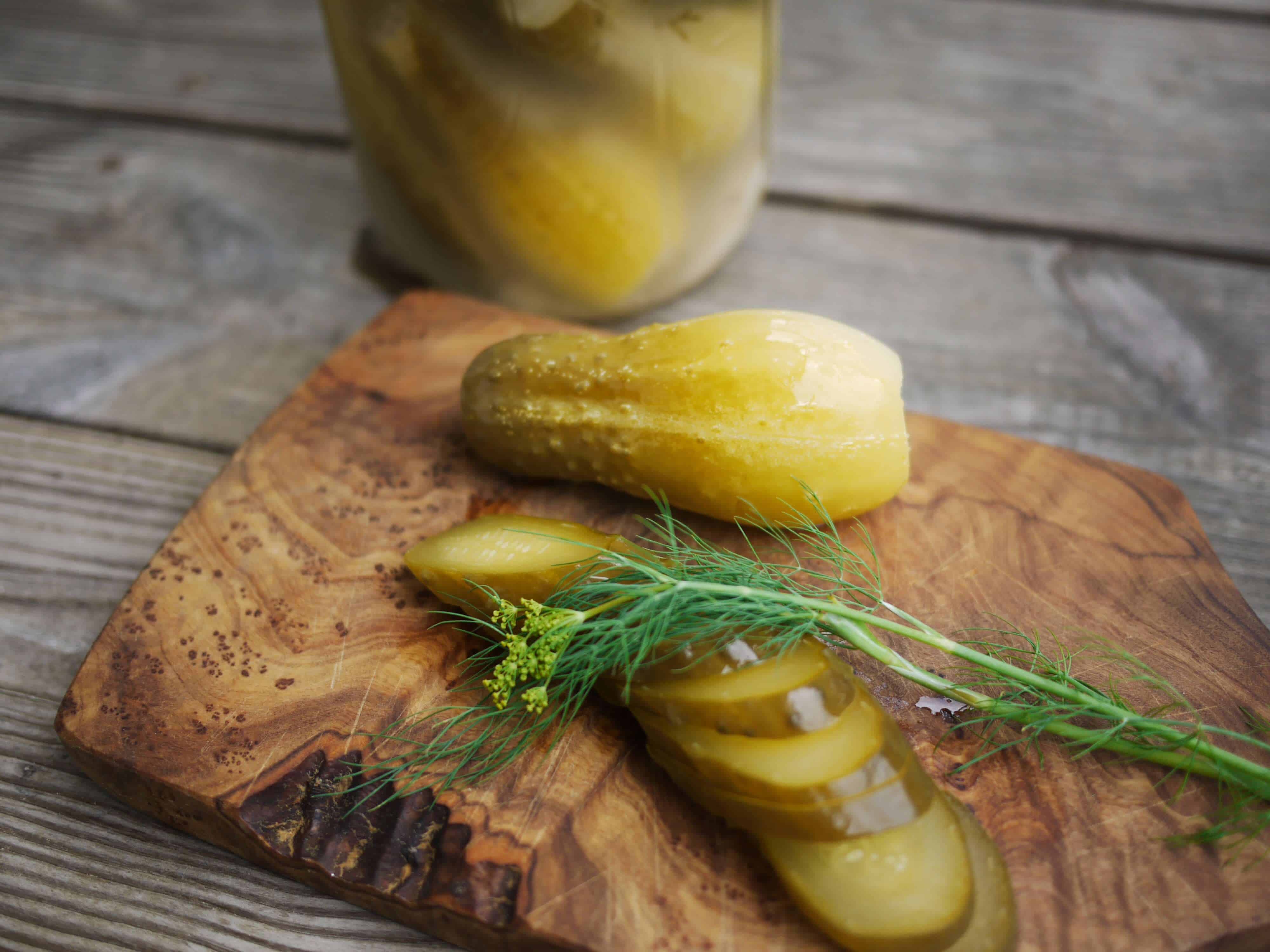 Sliced homemade pickles and jar