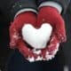 Snow heart in gloved hands