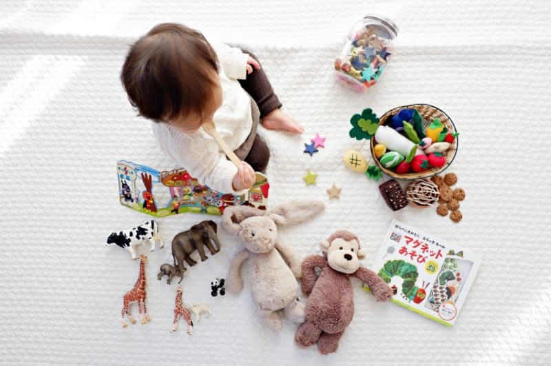 toddler playing with various toys