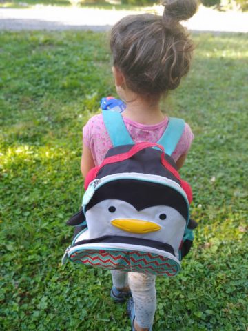 Girl with penguin backpack